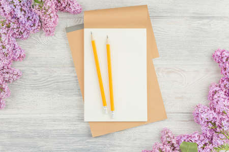 School notebook with pencil on wooden table.