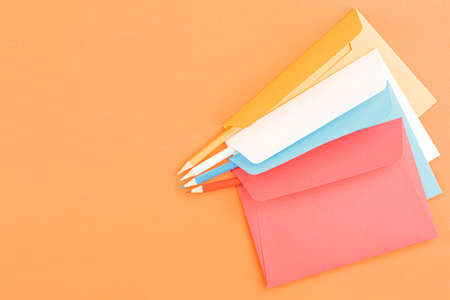 Colored postage envelopes with colored pencils.の写真素材