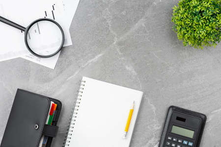 Open notebook with calculator, office desk.