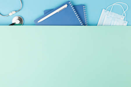 Stethoscope with notepad on the nurse desk.の写真素材