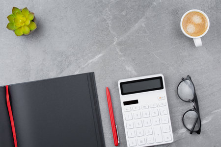 Black notepad on marble background.