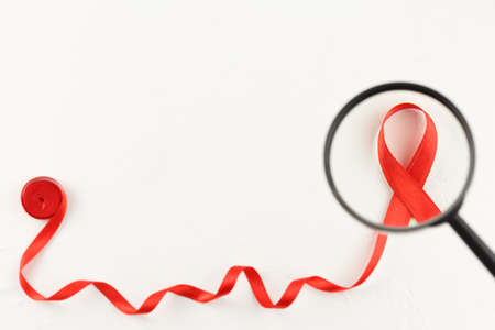 Cancer ribbon with magnifying glass