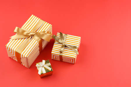 Gifts in colored paper with bows and paper sheetの写真素材