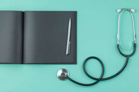 Notepad with stethoscope on the table.