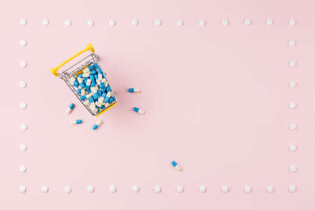 Pills on a pink table.の写真素材