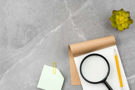 Open notepad on gray marble background