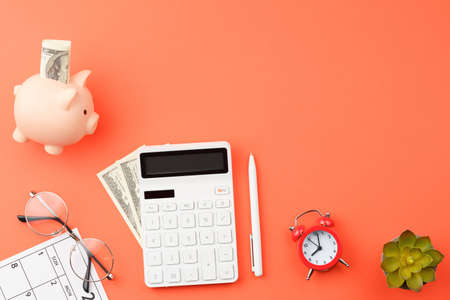 Office desk with calendar, calculator and glasses.
