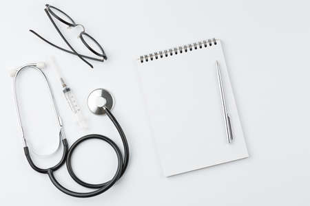 Doctor desk with stethoscope and glasses.の写真素材