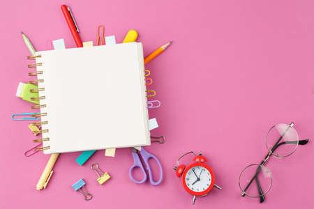 Notepad with pencil on pink background.の写真素材