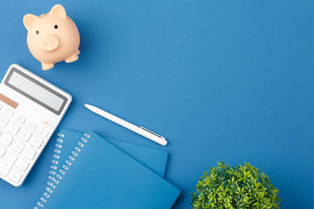 Notepad, pen, piggy bank, calculator and pen.の写真素材