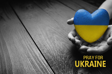 ukraine heart yellow blue color in handsの写真素材