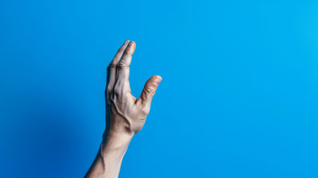 hand asking for help on blue background closeup. hand reaching up, salvation of mankind concept, by ai generativeの素材