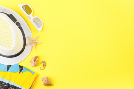 Beachwear and shellfish souvenirs on yellow background.の写真素材