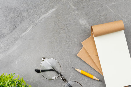 Open notepad on gray marble background.の写真素材