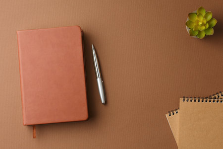 Personal diary with a pen and a potted plant.の写真素材