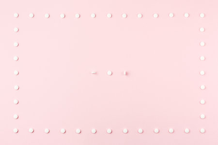 Pills on a pink table.の写真素材