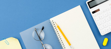 Notepad, pencil, calculator, note sheet, glasses.の写真素材