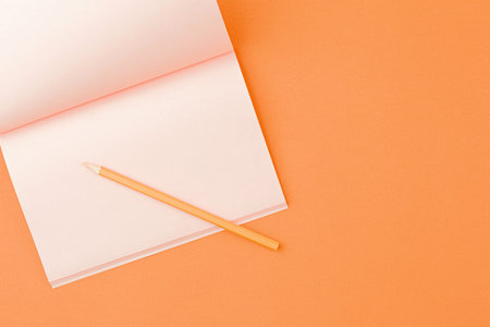 Pink notebook with colored pencils.