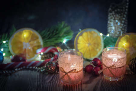 A Couple of Magic Christmas decorated Burning candles on wooden rustic background 3.の写真素材