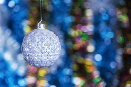 Close up elegance christmas decoration balls with shiny glare hanging on abstract glitting color background with copy space for postcard.の写真素材
