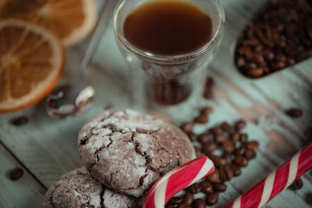 Black coffee in glass cups with christmas decoration and candies. Close view on cookies.の写真素材