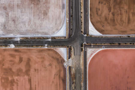 Aerial shot of crossroads at salt factory in Santa Pola, Alicante, Costa Blanca, Spain. Salty pink...