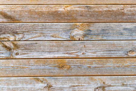 Old scratched wooden background with pieces of old paint and screws nails. Rustic obsolete boards of wall, door or floor. Selective focus.の写真素材