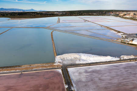 Aerial shot of salt factory in Santa Pola, Alicante, Costa Blanca, Spain. Salty pink red lakes on...