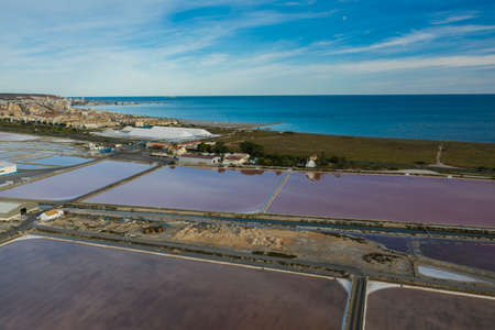 Aerial shot of salt factory in Santa Pola, Alicante, Costa Blanca, Spain. Salty pink red lakes on mediterranean sea coastの写真素材