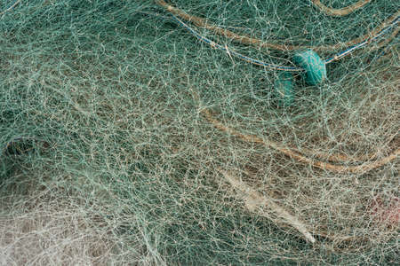 Abstract background of mesh of fishing net with light beam. Close up view with selective focus.の写真素材