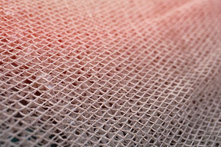 Close up view of fishing net in marine port in the morning. Selective focus. Blurred pattern background.の写真素材