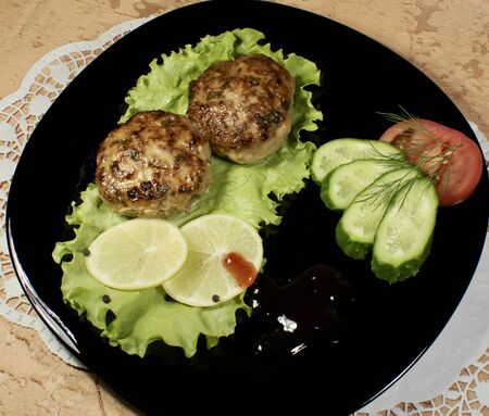 Dish of cutlets, lettuce, tomato and cucumberのeditorial素材