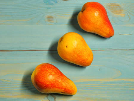 Separate three pears on blue-gray, wooden, background, proper nutrition, Lifestyle, Close-up,