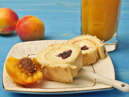 Cream rolls on a plate and apricots and abrix juiceの写真素材