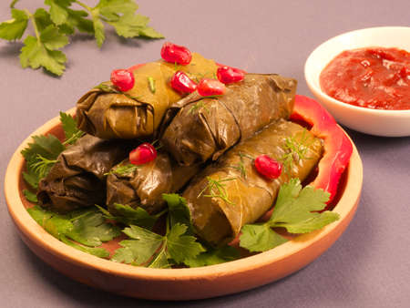 Meat dolma - Minced pork and beef, grape leaves, hot pepper, onion, garlic, rice, utsho-suneli. Close up. Macrophotography.の写真素材