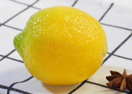 Lemon, yellow, young on a light napkin. Close-up. Macrophotography. Proper nutrition.の写真素材