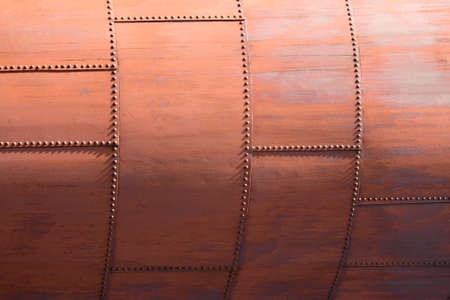 The skin of an old rusty blast furnace at an old factory.の写真素材