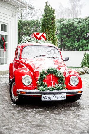 Christmas retro red car with present boxes on top . Cristmas Gifts Conceptの写真素材