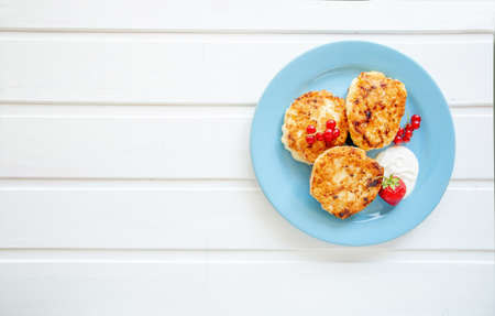 Cottage cheese pancakes with fresh blueberries and on woodene background. Top view. Copy space. Healthy breakfast conceptの写真素材