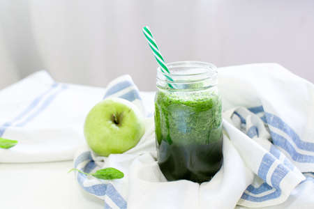 Green smoothie with apple and shinach. Summer and vegan foods and drinks concept.の写真素材