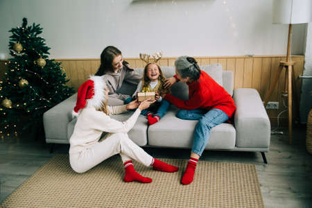 Same sex family with child celebrating Christmas. The female family celebrate Christmas together....