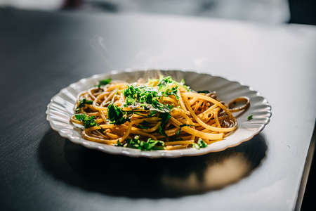 Italian spaghetti Aglio Olio. Traditional italian pasta with oil and garlic on the blasck tableの写真素材