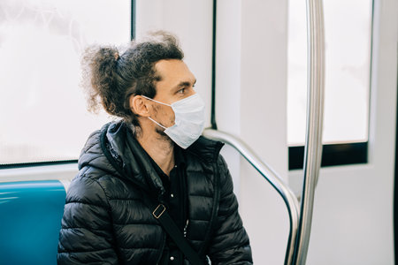 Man wearing protective face mask in the metro. Social distancing to crowd while commuting in the Rome underground.の写真素材