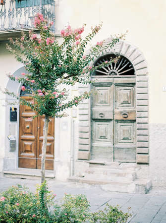 Building with beautiful authentic doors. Lucca, Tuscany, Italy. Typical Italian street.の写真素材