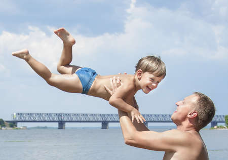 Father throwing kidの写真素材