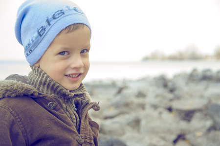 Little cute kid on river