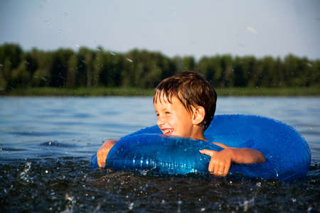 Boy relaxing on a water tubeの写真素材