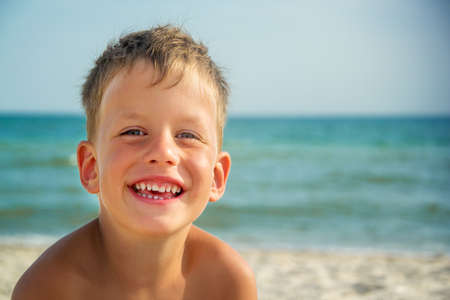 Portrait of four years boy on beachの写真素材