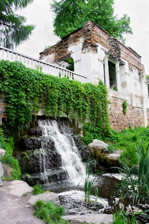 Ruins with waterfall in summer parkの写真素材