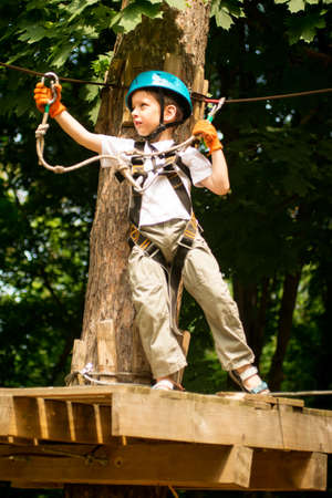 Five year boy on rope-way in the forest